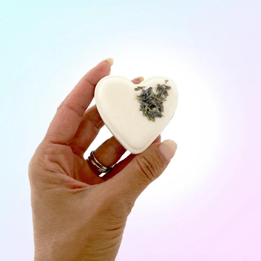 ErosWell heart shaped bath bomb with lavender flowers held in hand